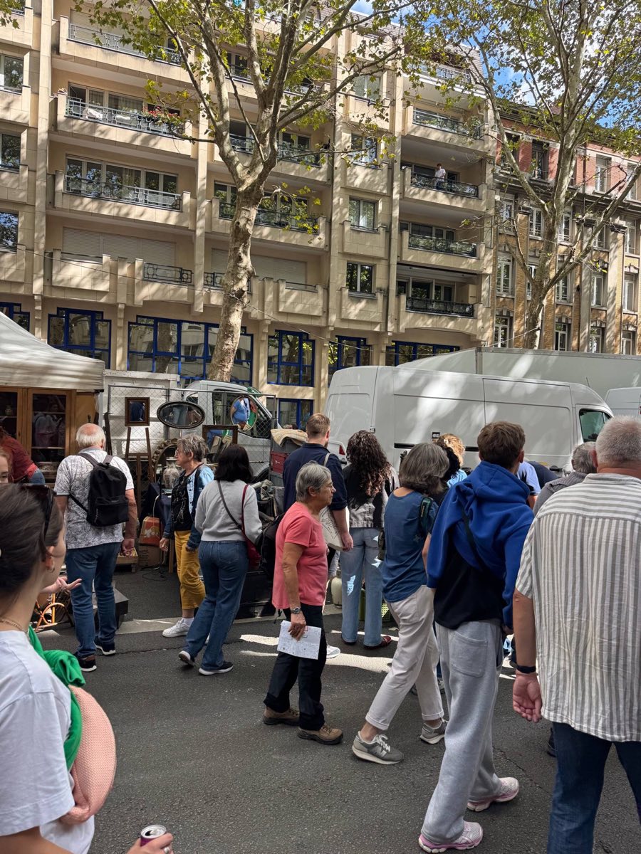 Dense crowd of shoppers walking past dealer vans and stalls at the Braderie de Lille flea market