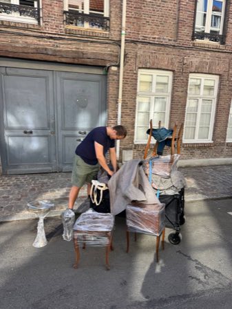 Strapping down a trolley load of wrapped antique furniture