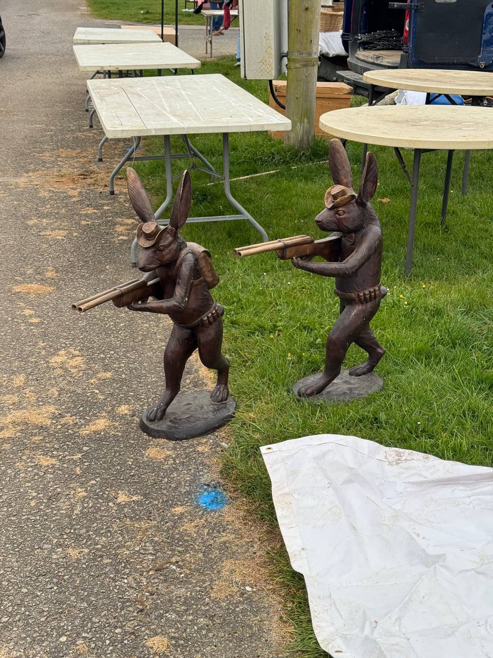 Quirky vintage find at a UK car boot sale — pair of antique brass rabbits with rifles, the kind of unusual stock that flips well on eBay