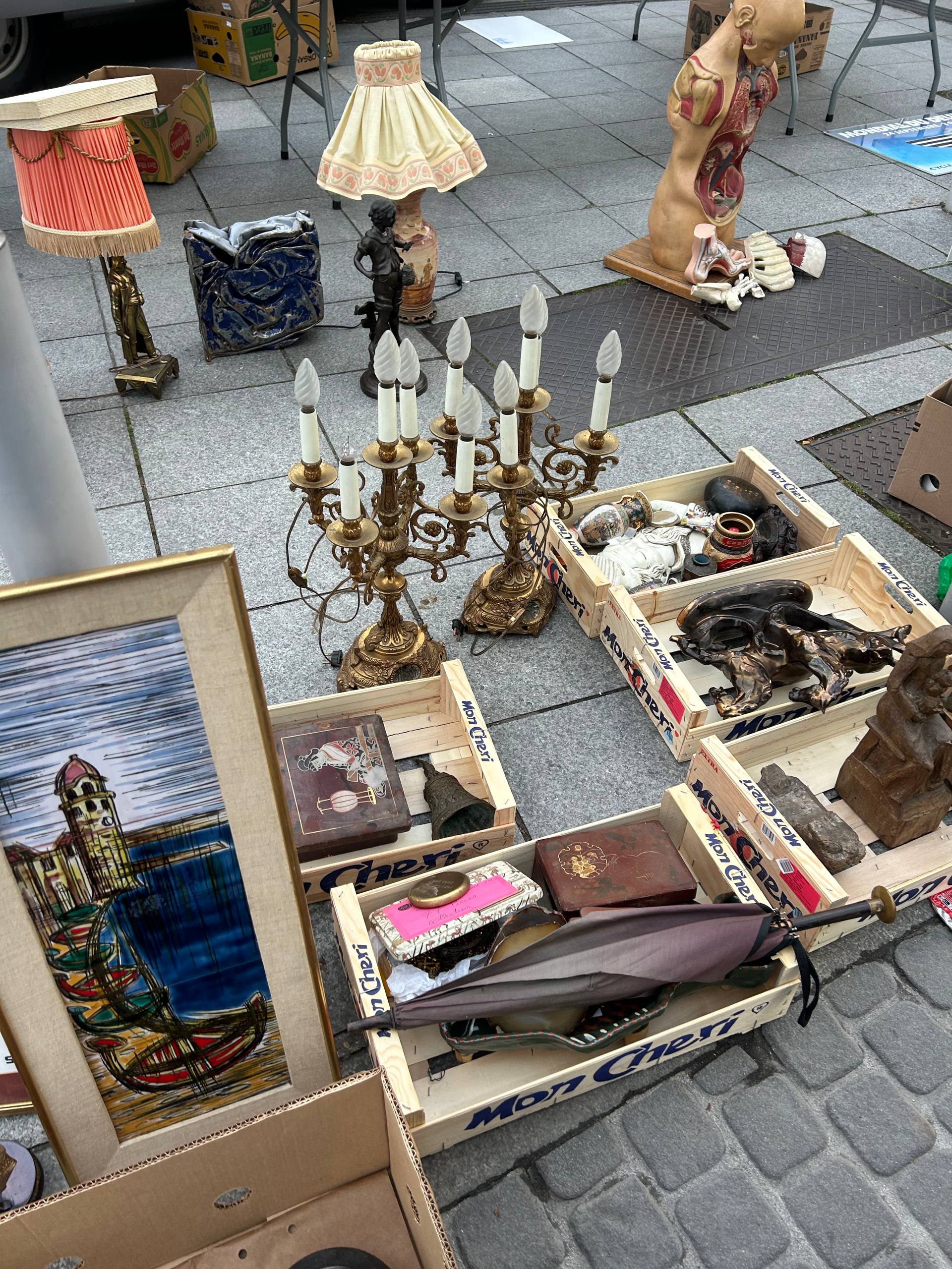 French brocante seller stall with vintage inventory laid out — UK reseller sourcing trip