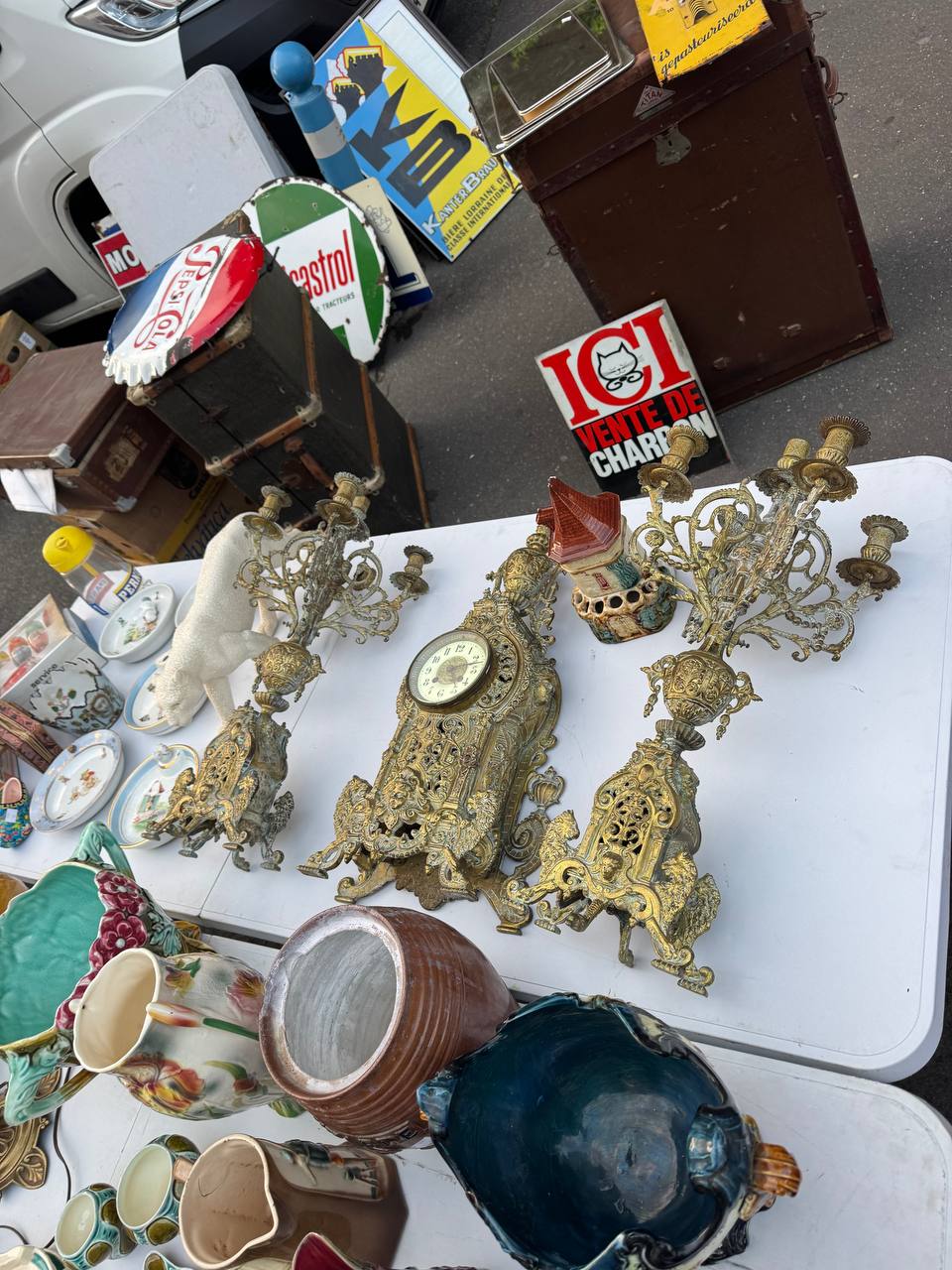 French brocante seller stall with vintage candelabras and antique clock — Northern France