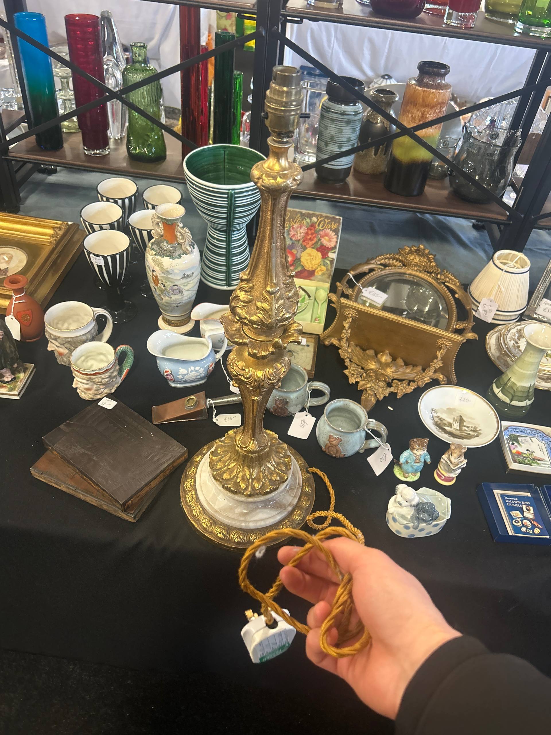 UK car boot sale seller stall with vintage items, ceramics, and bric-a-brac