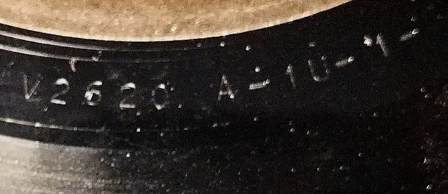 Close-up photo of a matrix number etched into the runout groove of a vinyl record